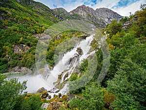 Kleivafossen waterfalls and mountains near briksdalsbreen Glacier in Norway
