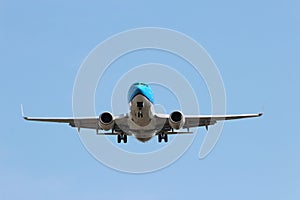 KLM Embrear aircraft landing on the landing strip of Amsterdam Schiphol Airport