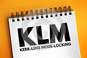 KLM - Kerr lens mode locking acronym text on notepad, abbreviation concept background