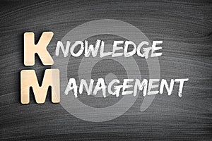 KM - Knowledge Management acronym, business concept on blackboard photo