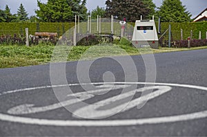 In a 30 kmh zone a speed camera is located in a trailer to automatically flash too fast drivers photo