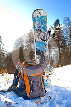 Knapsack near the snowboard