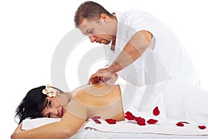 Kneaded massage on woman back at spa