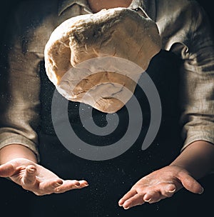 Kneading the dough, the cook throws the dough. Levitation of food.