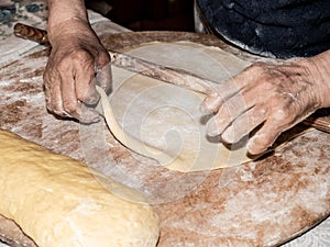 Kneading the sweet pizza manually is Italian peasant tradition with ancient and healthy method, with the hands of an old lady