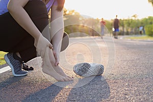 Knee Injuries. Young sport woman holding knee with her hands in pain after suffering muscle injury during a running workout at the