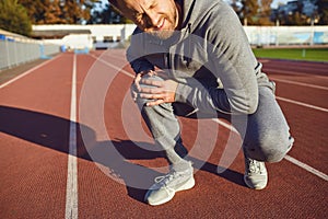 Knee injury in training.Man injured his leg during exercise.