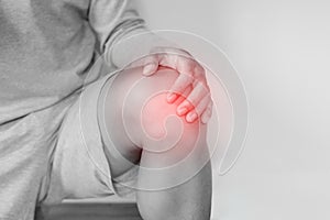 Knee joint pain, a man suffering from knee pain , on white background photo