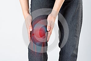 Knee pain, man with legs ache, chiropractic treatments concept on gray background
