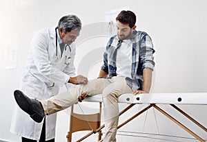 Knee pain, patient and doctor in clinic, health care and help at wellness checkup of person at hospital. Medicine