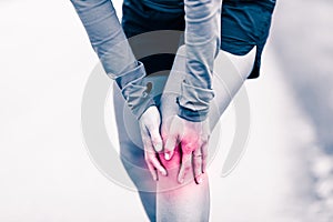 Knee pain, woman holding sore and painful leg photo