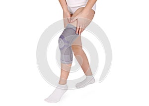Knee Support Brace on leg isolated on white background. Orthopedic Anatomic Orthosis.