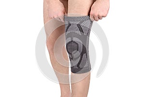Knee Support Brace on leg isolated on white background. Orthopedic Anatomic Orthosis. photo