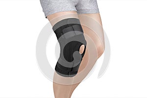 Knee Support Brace on leg  on white background. Orthopedic Anatomic Orthosis. Braces for knee fixation, injuries and pain.