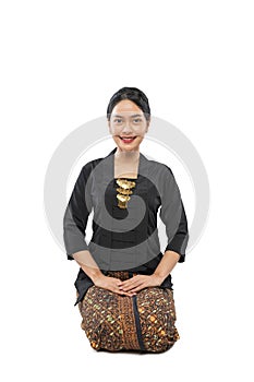 kneel on the floor woman wearing traditional Javanese dress Kebaya