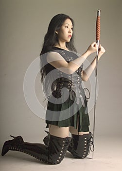 Kneeling Asian warrior with sword