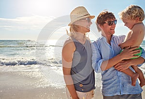 We knew youd love the beach. a young family enjoying a summer day out at the beach.