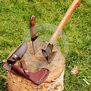 Knife and axe on log