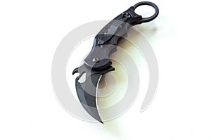 Knife blade in the form of a claw. Knife on a white background. Black tactical knife.