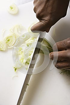Knife chopping fennel.