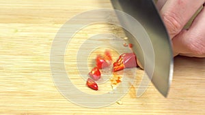 Knife Cut Chilli Pepper on Wooden Cutting Board. Hot Spicy Food concept