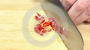 Knife Cut Chilli Pepper on Wooden Cutting Board. Hot Spicy Food concept