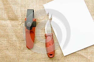 Knife and cut a sheet of paper.