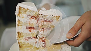 A knife cuts a birthday cake at an event.