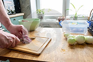 Knife is cutting raw meat. Chef is cooking pork. Ingredient of high-calorie dish. Preparation of dough for dumplings