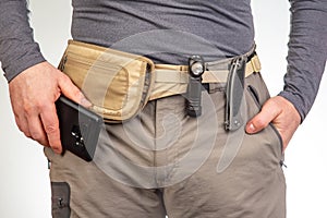 knife and flashlight with clips on the waistband of trekking pants. EDC items