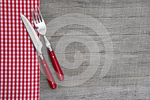 Knife and fork - bavarian country style table decoration on a wooden background photo