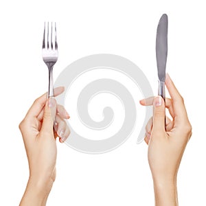 A knife and fork being held by womans hands. photo