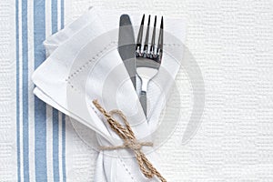 Knife and fork with blue and white linen