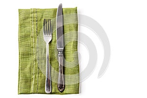 Knife and fork with green linen napkin