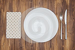 Knife, fork, napkin and dinner plate