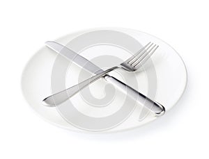 Knife and fork over the plate isolated