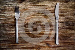 Knife and fork set on a wooden table