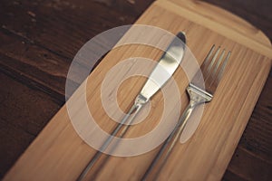 Knife and fork on a wooden table