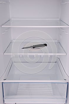 Knife inside in empty clean refrigerator