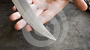 Knife with its blade in hand