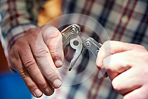 Knife multitool turned into pliers in the hands