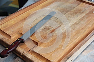 Knife resting on wooden cutting board