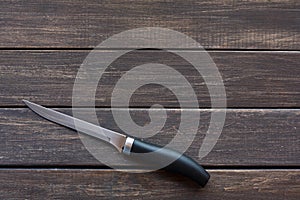 Knife on rustic wood background, copy space