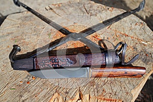 Knife and scabbard. hunting knife. the knife on the wood.