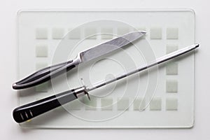 Knife and sharpener on the white background