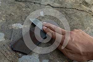 Knife sharpening on knife sharpening stone.