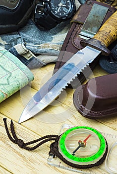 Knife surrounded by tourist equipment