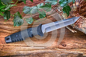 Knife Tanto with Katana tip, into the wood. photo