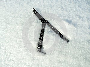 A knife thrown in the snow after committing a crime.