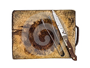 Knife and tongs on a wooden chopping board isolated on white background,vintage tone